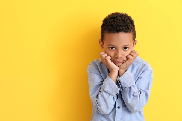 Cute African-American boy on color background - Foto, Imagen