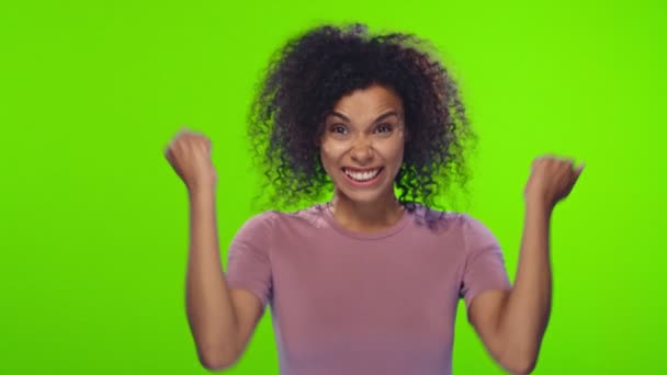 Portrait african american young woman with curly hair rejoices in victory - 映像、動画
