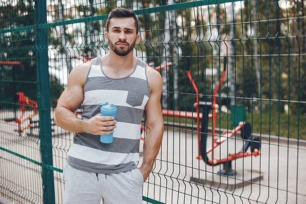 Sports man in a morning summer park - Fotografie, Obrázek