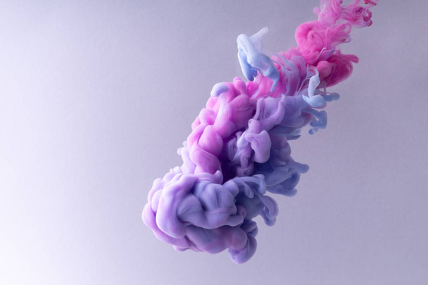 Colorful Ink swirling in water. Cloud of silky ink on white background. - Foto, Imagen