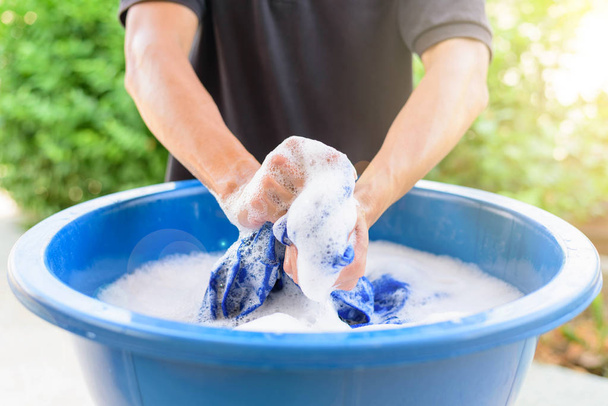 hand washing clothes in Blue basin with sunlight - Фото, зображення