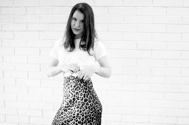 Fashionable portrait of a sexy girl in clothes with animal print - 写真・画像