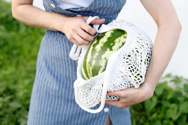 Summer lifestyle image. Watermelon, in cotton shopping bag, hipster girl - Foto, Imagem