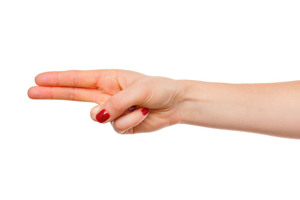 A mão da mulher aponta um dedo para algo isolado no fundo branco
 - Foto, Imagem