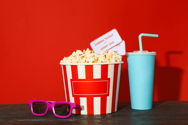 3D-Brille, gestreifter Eimer mit Popcorn und Eintrittskarten, Pappbecher - Foto, Bild
