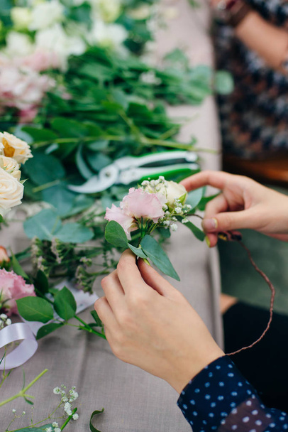 Female florist unfocused in flower shop. Floral design studio, making decorations and arrangements. - Fotografie, Obrázek