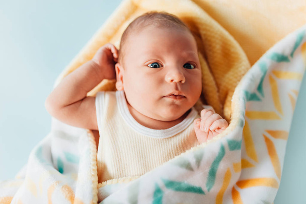 a newborn baby, a beautiful baby who smiles, in a warm blanket - Photo, Image