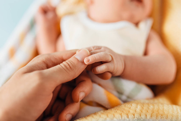 newborn baby, hands close-up, lying on a soft blanket - Φωτογραφία, εικόνα