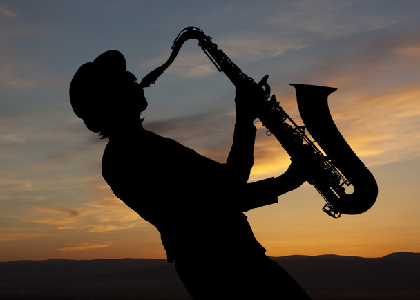 Saxophonist at sunset - Фото, зображення