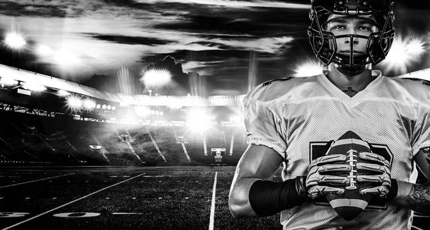 American football player, sportsman in helmet on stadium. Black and white photo. Sport wallpaper. - 写真・画像