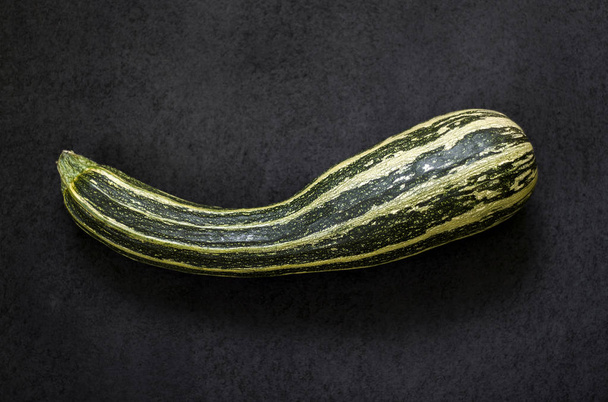 Fresh zucchini on black textured background - Photo, Image