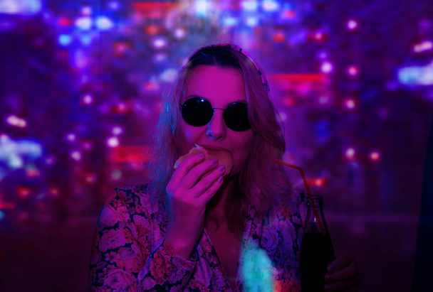 woman in sunglasses with girl neon light reflection - Фото, изображение