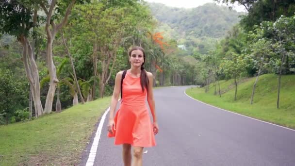Beautiful Rain forest with a young woman traveler on the road into the forest Thailand. Female walks on a rain forest road and enjoys the views of nature - Záběry, video