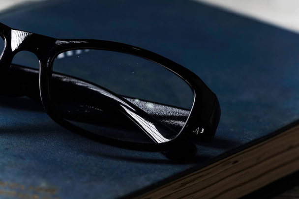 An eyeglasses and a book - Фото, зображення