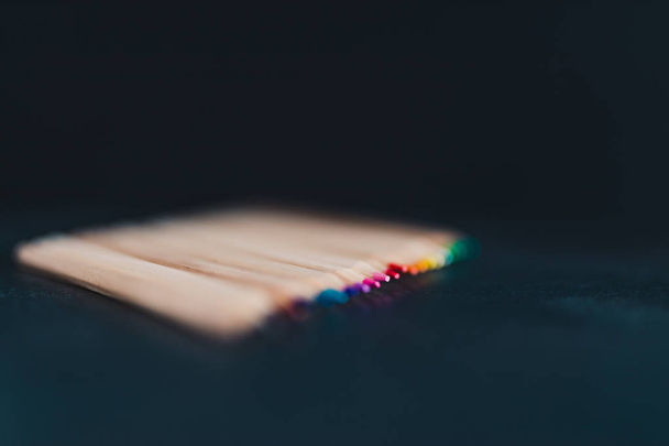 set of coloured pencils on desk on dark background shot at exrem - Valokuva, kuva