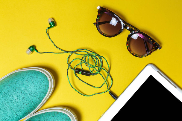 sunglasses, earphones, shoes and a phone - Fotó, kép