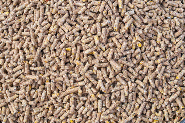 Achtergrond textuur van gemalen zaad en graan mengsel voor vee en vogel voeding - Foto, afbeelding