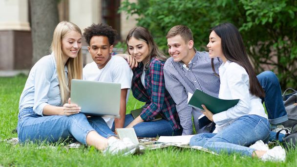 Students studying in group project outdoors in college campus - Photo, Image