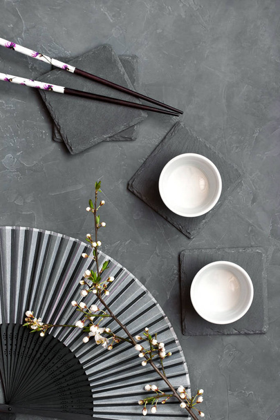 Chopsticks and bowls with cherry flowers - Foto, imagen