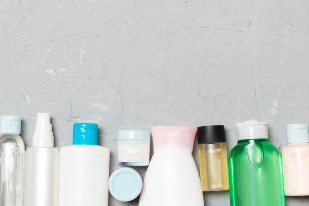 Flat lay composition with cosmetic and cream bottles on cement background. Beauty products concept with copy space - Photo, Image