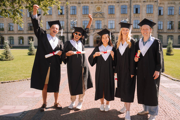 Group of students standing together after the graduation. - Fotoğraf, Görsel
