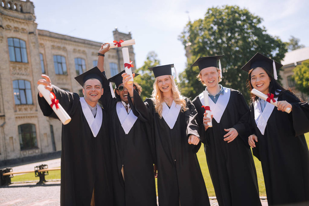 Cheerful students celebrating their graduation from the university. - Foto, imagen
