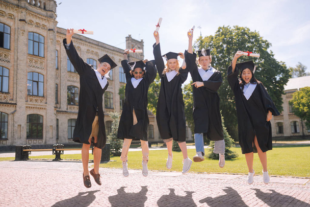 Students being excited graduating the university together. - Valokuva, kuva