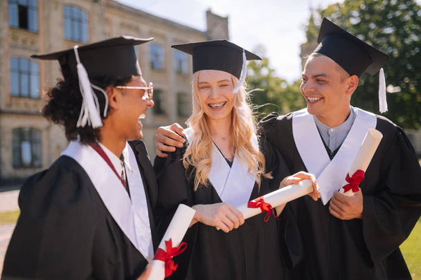 Three students being happy to graduate from the university. - Zdjęcie, obraz