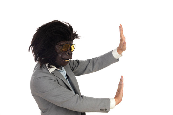 Businessman with gorilla head gesturing - 写真・画像
