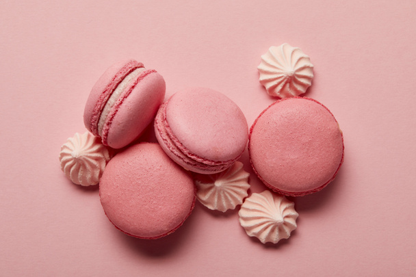 Pink macaroons with pink meringues on pink background - Фото, изображение