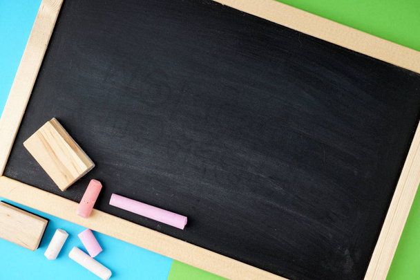 empty space on black board and colorful chalks  - Foto, Bild