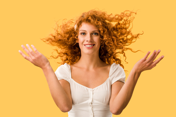 happy woman with curly red hair, isolated on yellow - Photo, Image