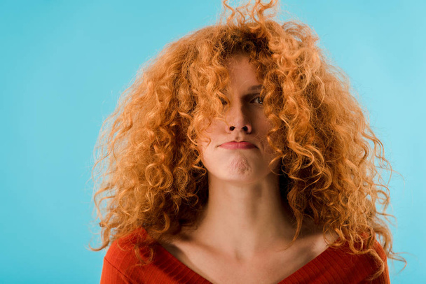 portrait of beautiful redhead young woman isolated on blue - Φωτογραφία, εικόνα