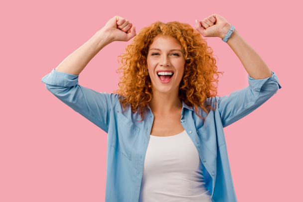 excited redhead woman gesturing Isolated On pink   - Фото, зображення