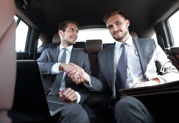 handshake business partners in the car. - Photo, Image