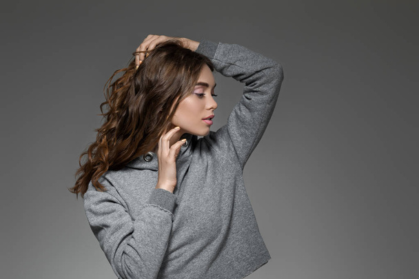 portrait of woman with long hair in gray sweater - Photo, image