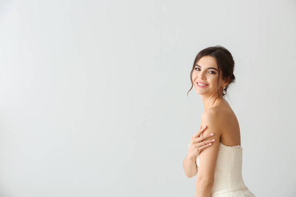 Beautiful young bride on light background - Фото, зображення