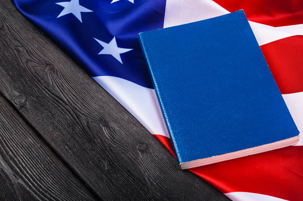 Bible laying on top of an american flag - Фото, зображення