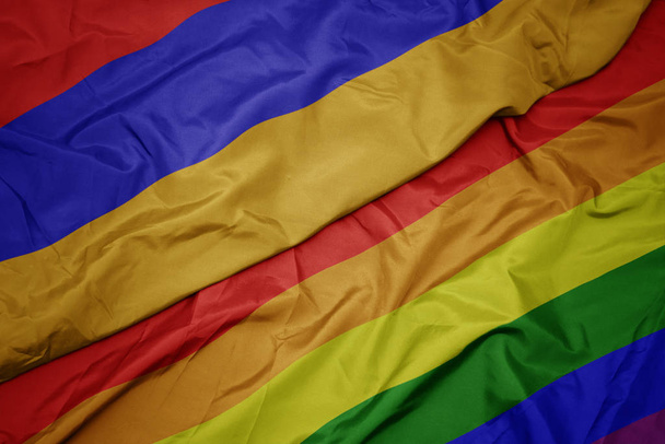 waving colorful gay rainbow flag and national flag of armenia. - Photo, Image