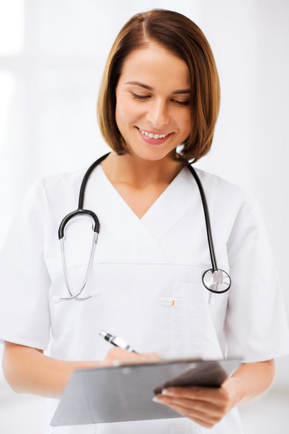 Female doctor with stethoscope and clipboard - Φωτογραφία, εικόνα
