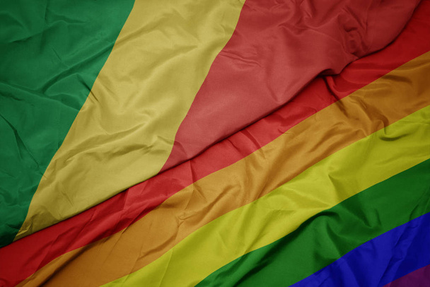waving colorful gay rainbow flag and national flag of republic of the congo. - Photo, Image