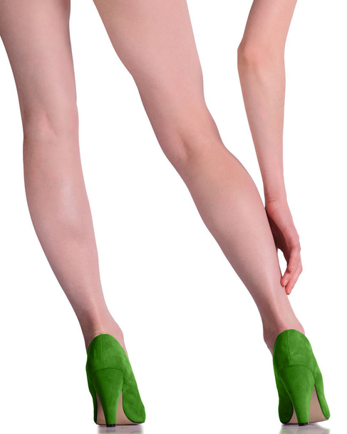woman legs in shoes on grey background - Foto, Imagen