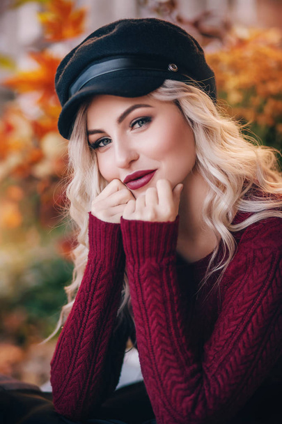  beautiful blond  woman with makeup in burgundy sweater - Photo, Image
