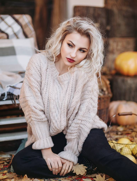  beautiful blond  woman with makeup in white sweater - Fotografie, Obrázek