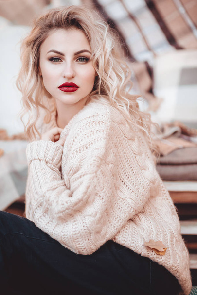  beautiful blond  woman with makeup in white sweater - Zdjęcie, obraz