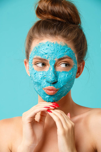 Beauty treatment - woman applying clay face mask - Photo, Image