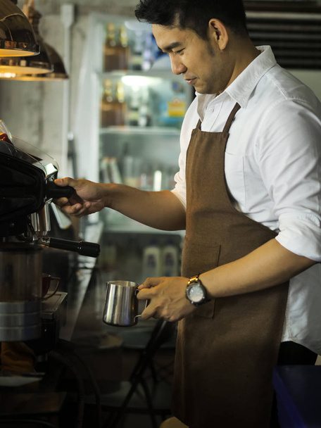 Happy Asian barista man working in cafe, lifestyle concept. - Фото, зображення