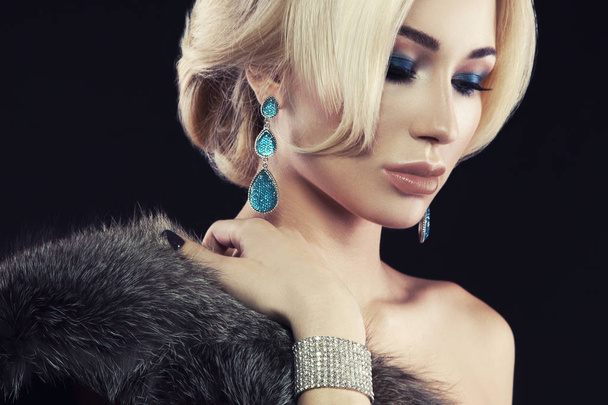 Portrait of young blonde woman with trendy accessories and stylish makeup posing on black background - Valokuva, kuva
