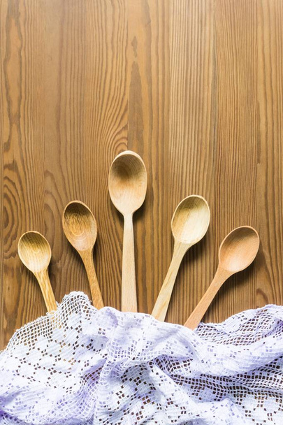 Wooden spoons on a vintage wooden background. Flat lay, top view, copy space. - Foto, Bild