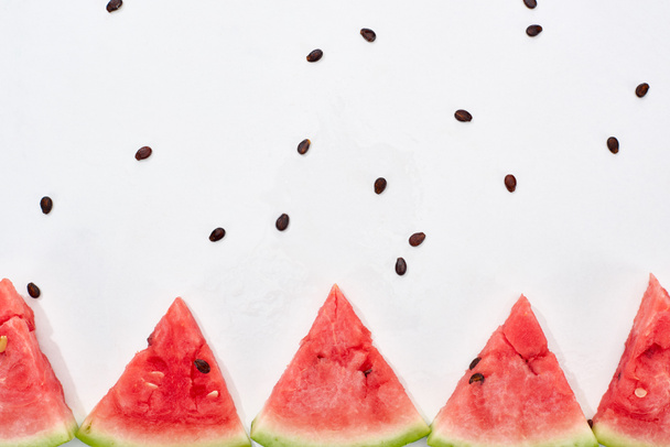 row of delicious juicy watermelon slices on white background - Fotó, kép